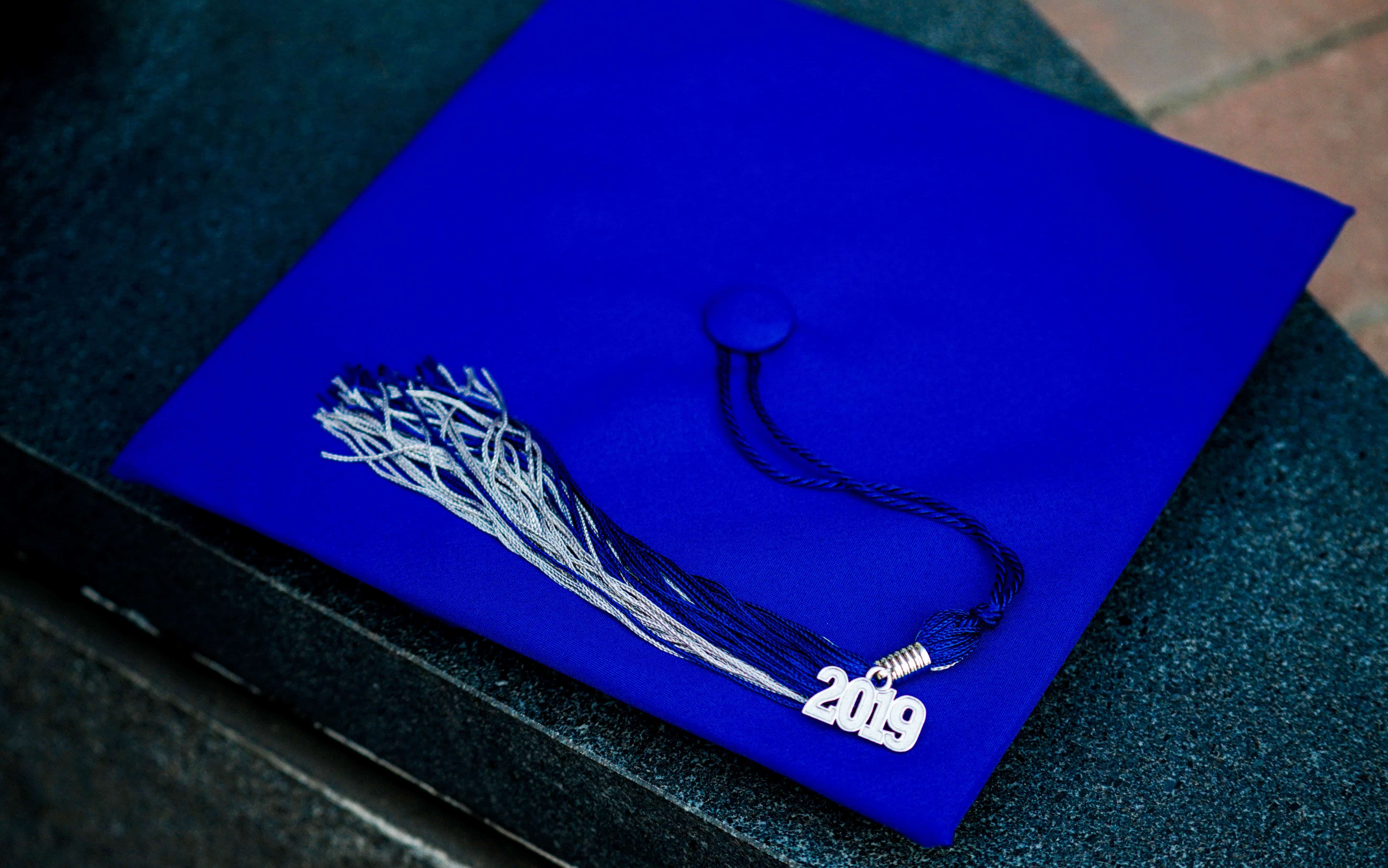 A graduation cap with a tassel that reads '2019', representing why some children need financial support after reaching the age of majority