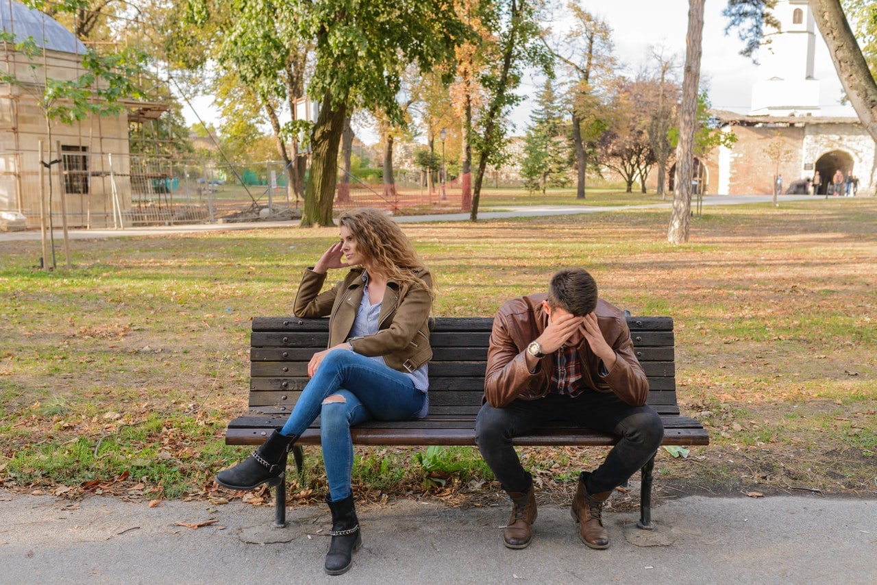 Couple on a bench in the midst of an argument