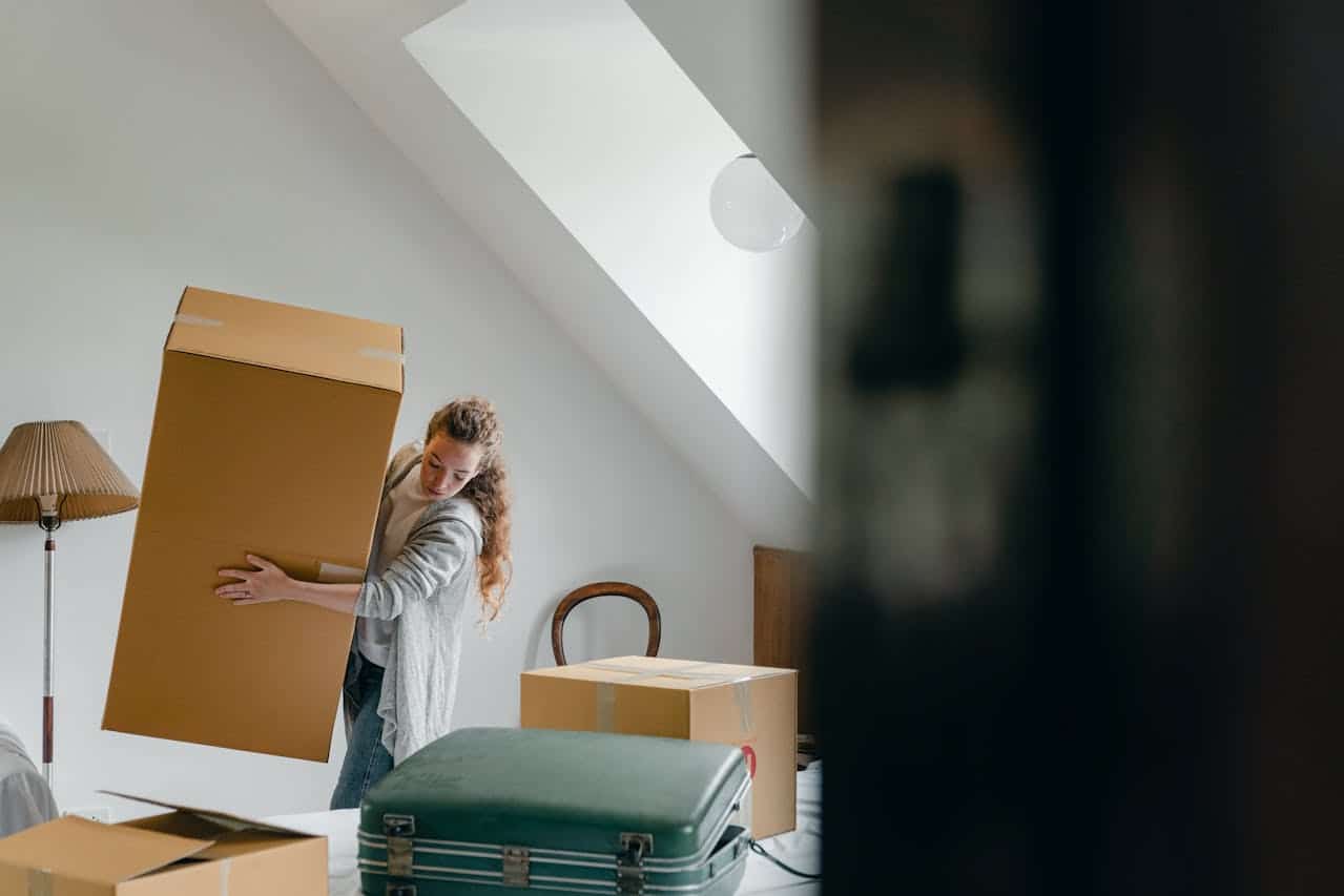 a woman moving boxes
